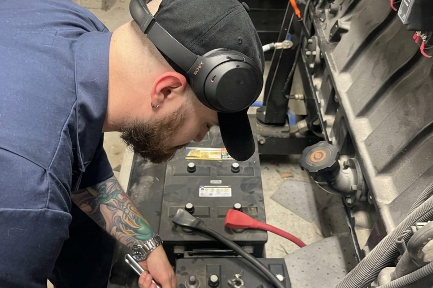 GenWorx technician servicing the starting batteries on a standby generator